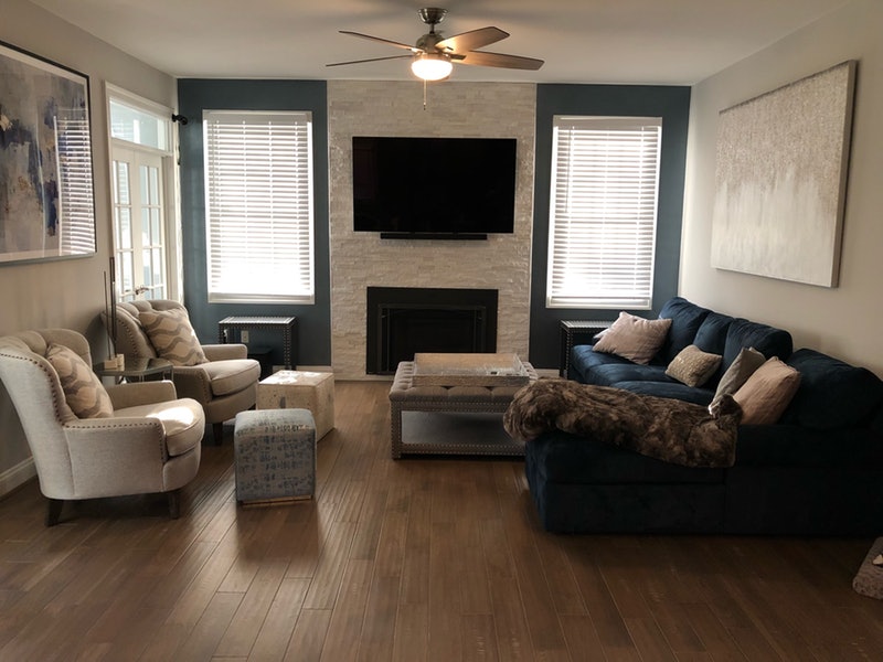 living-room-with-navy-velvet-sofa-and-fireplace-wall